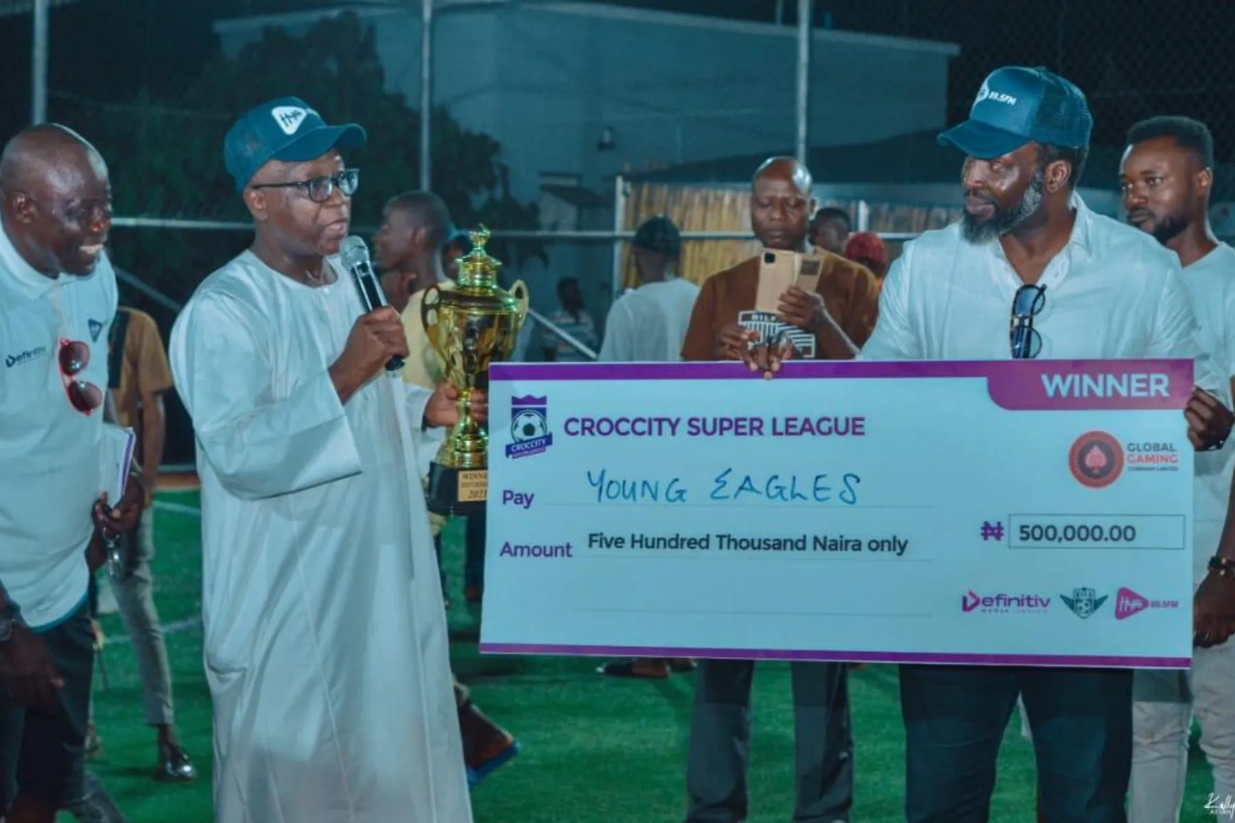 Croc City Soccer League winners receiving a trophy and prize cheque